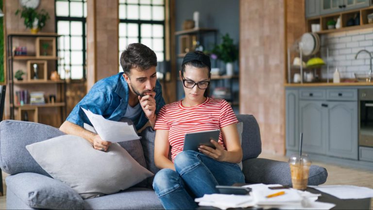 Young couple going over their cost of living expenses